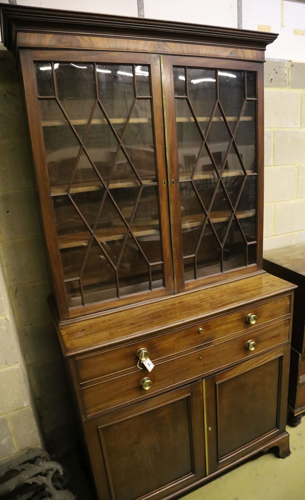 A George III mahogany secretaire bookcase, having astragal-glazed upper section, width 110cm, depth 56cm, height 224cm
